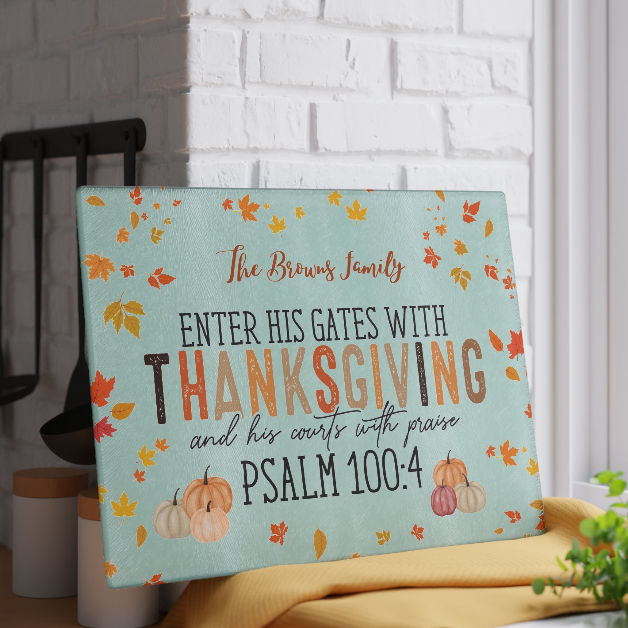 Decorative sign with fall-themed design and inspirational quote on a kitchen counter.