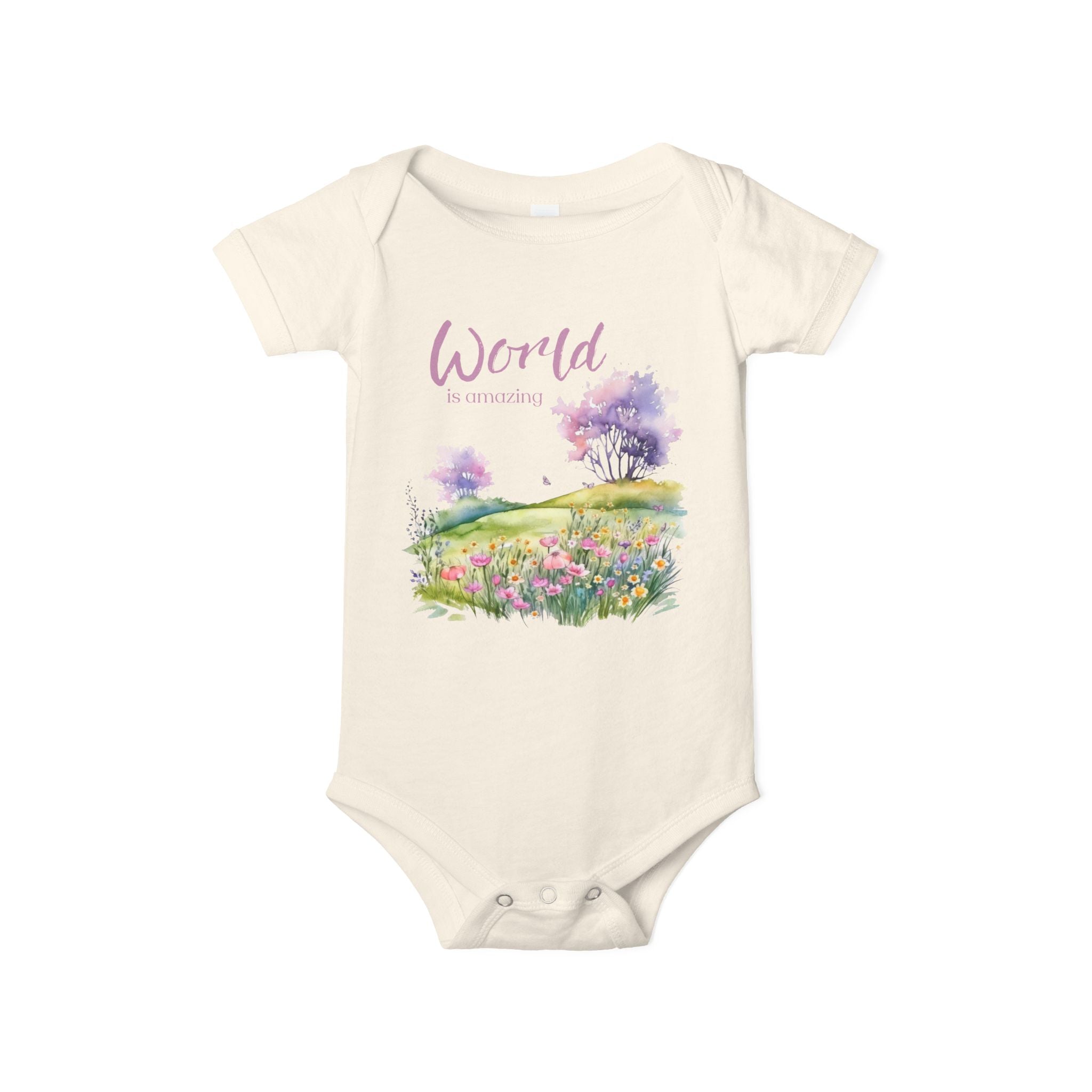 Baby onesie with "World is amazing" text and pastel nature design, made from soft 100% Airlume cotton, displayed flat with envelope neckline and snap closures.