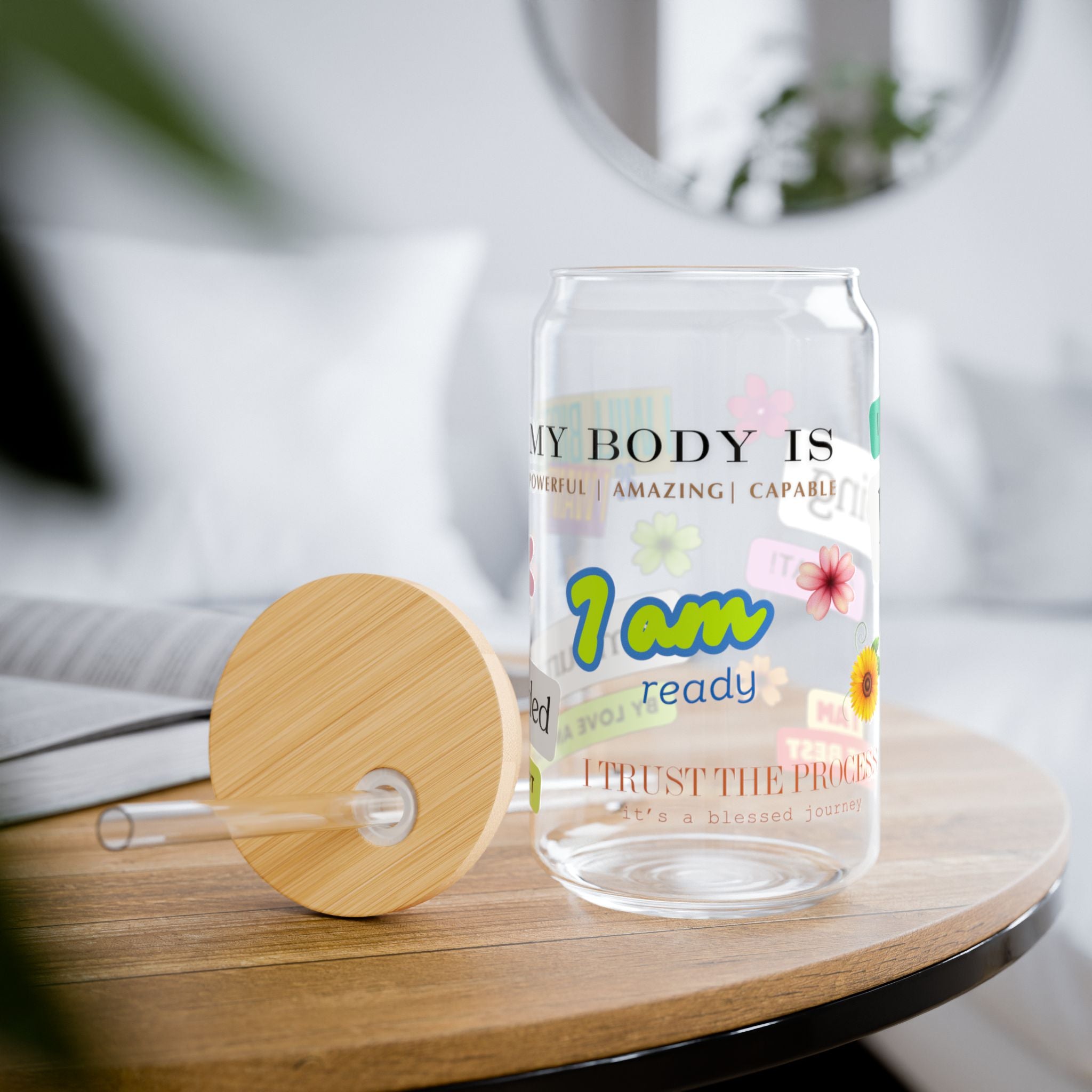 Glass with motivational text for birth and pregnancy and wooden lid on a table