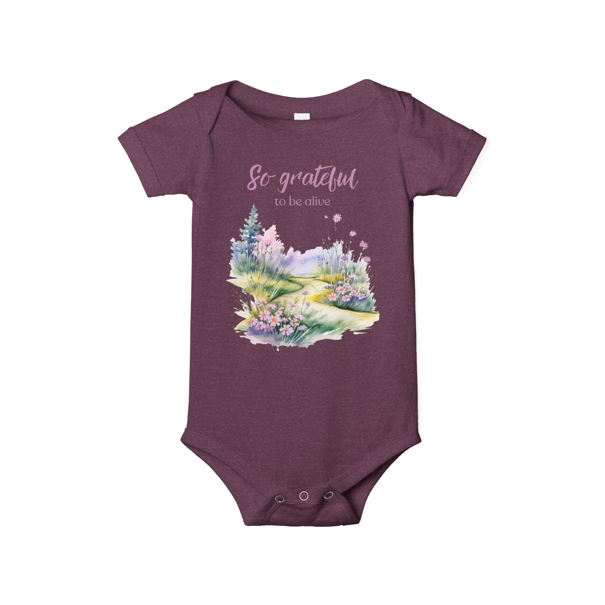 Baby onesie with "So grateful to be alive!" text and pastel nature design, made from soft 100% Airlume cotton, shown flat with envelope neckline and snap closures.