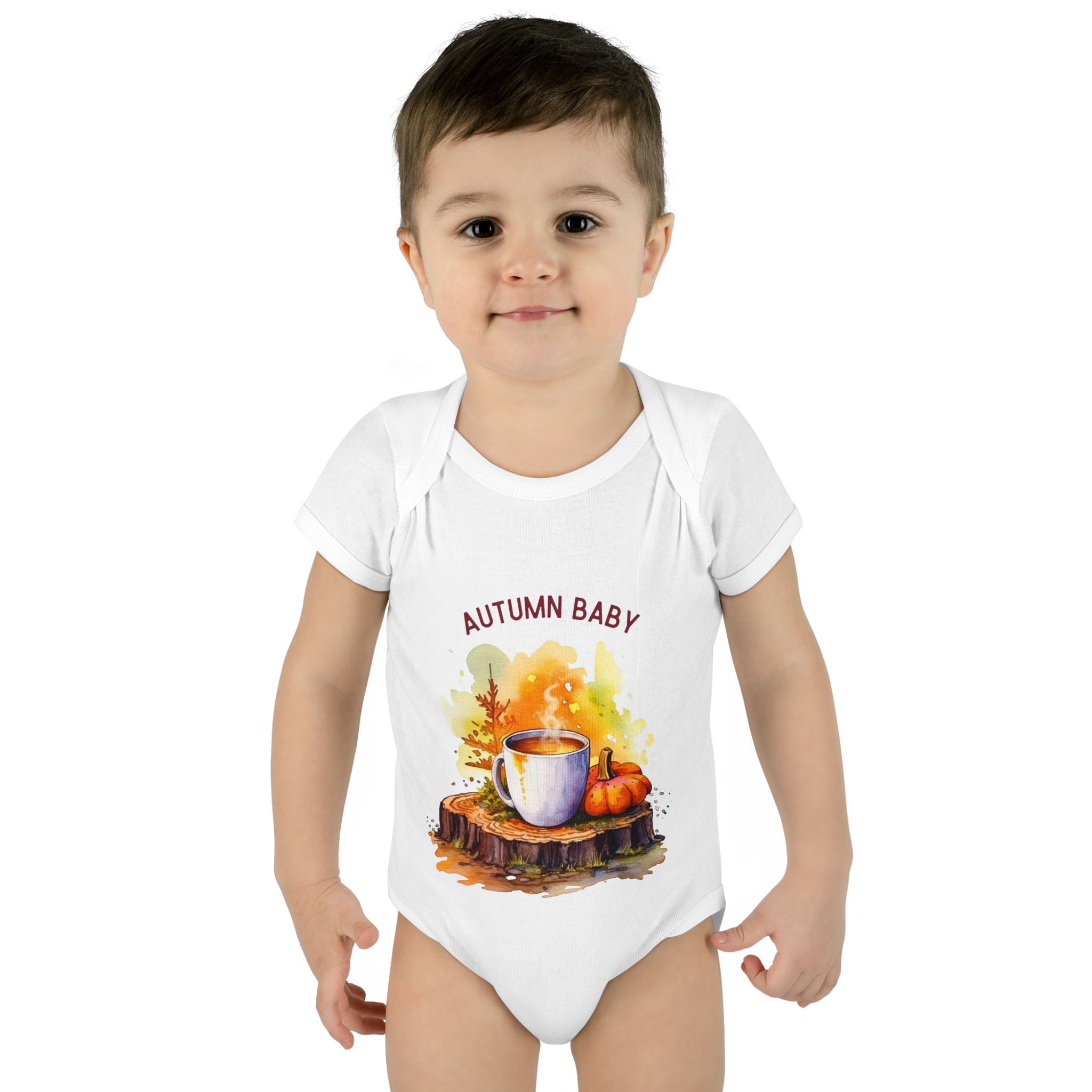 Child wearing a white onesie with 'Autumn Baby' and fall-themed design on a white background