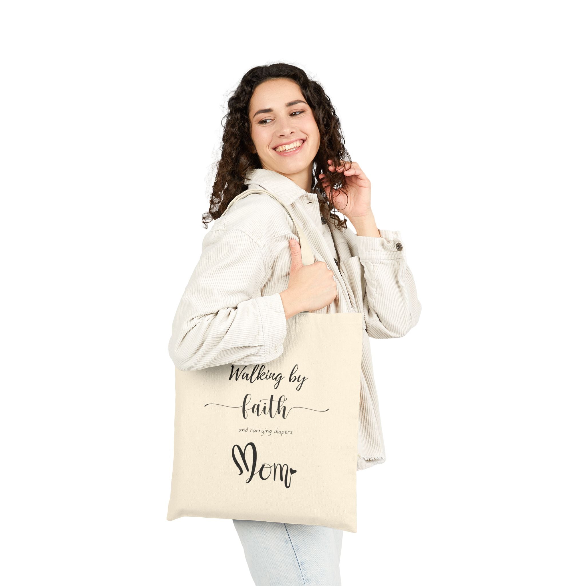 Natural cotton Christian tote bag with 'Walking by Faith and Carrying Diapers' text, designed for moms, featuring sturdy canvas handles and faith-inspired message.