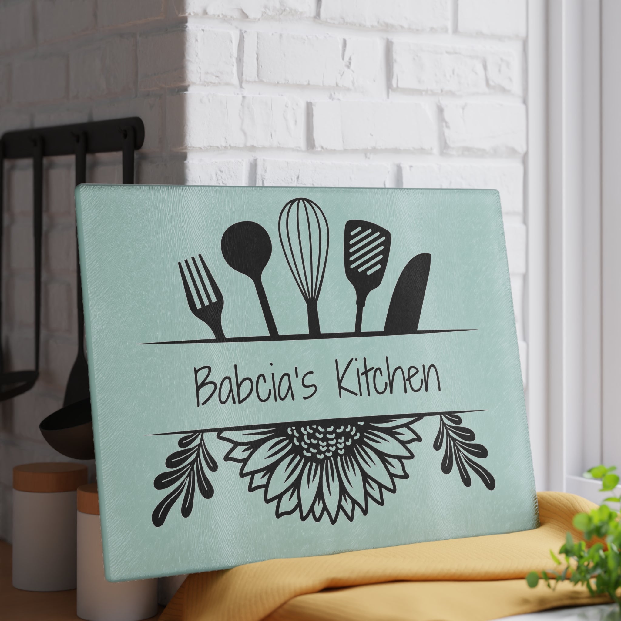 Decorative kitchen sign with utensil design and 'Babcia's Kitchen' text on a light blue background. For Polish babcia in the USA.