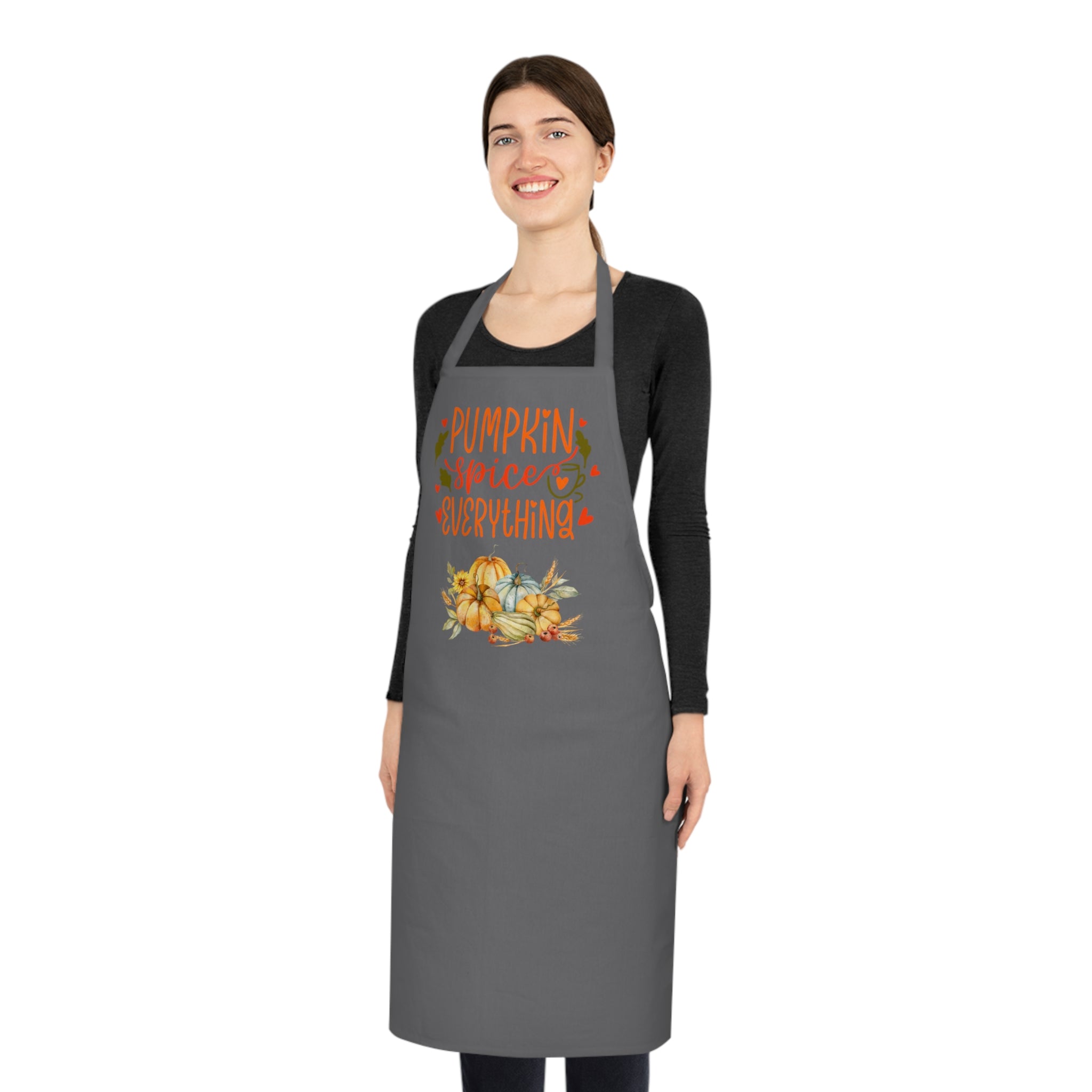 Woman wearing a gray apron with pumpkin spice everything design on a white background