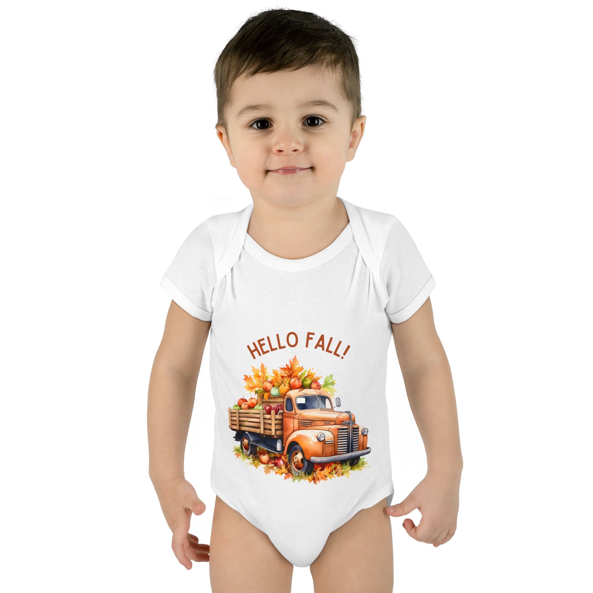 Child wearing a white onesie with a 'Hello Fall!' design featuring an orange truck and autumn leaves on a white background.