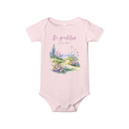 Baby onesie with "So grateful to be alive!" text and pastel nature design, made from soft 100% Airlume cotton, shown flat with envelope neckline and snap closures.