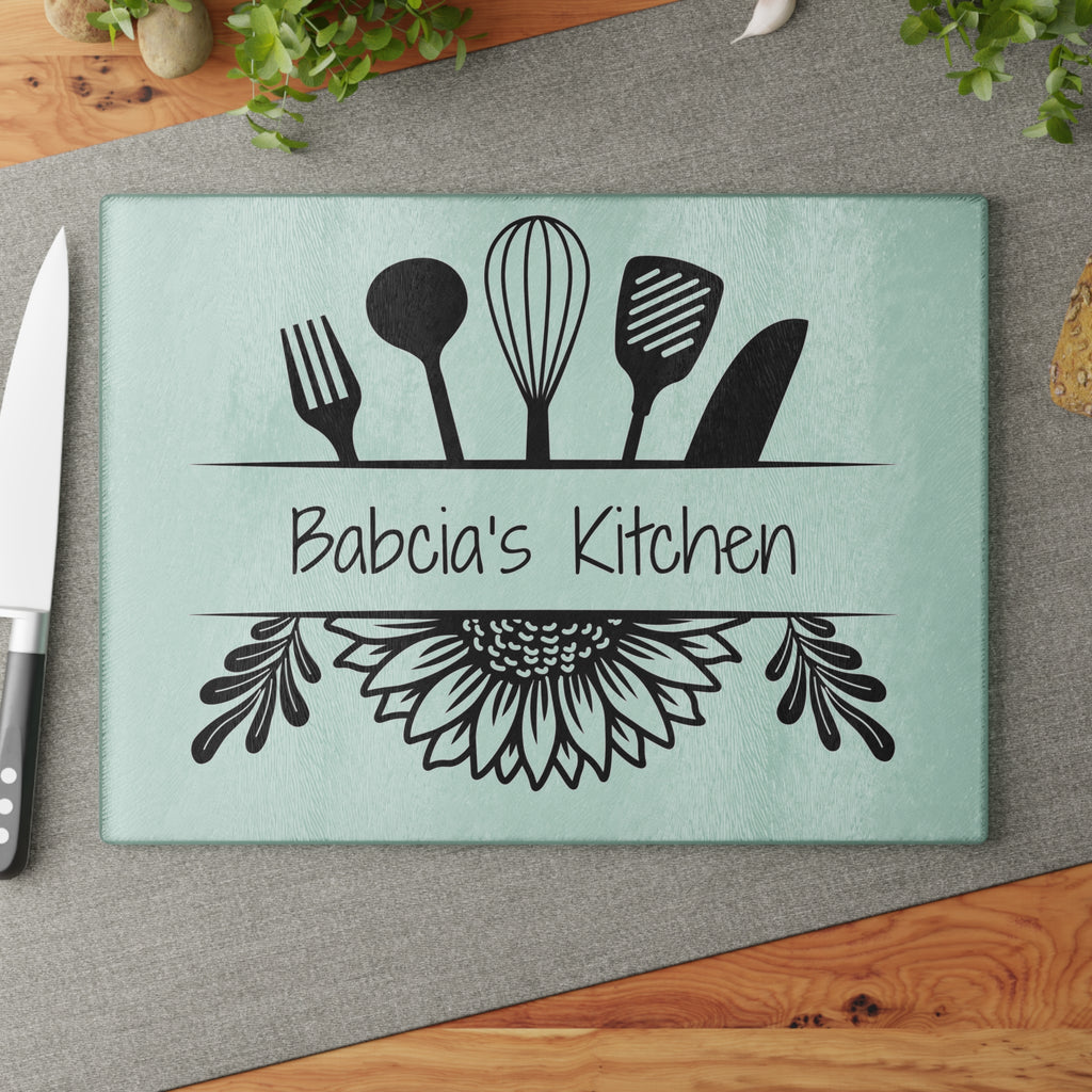 Decorative glass cutting board with utensil design and 'Babcia's Kitchen' text. For Polish babcia in the USA.