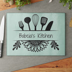 Decorative glass cutting board with utensil design and 'Babcia's Kitchen' text. For Polish babcia in the USA.