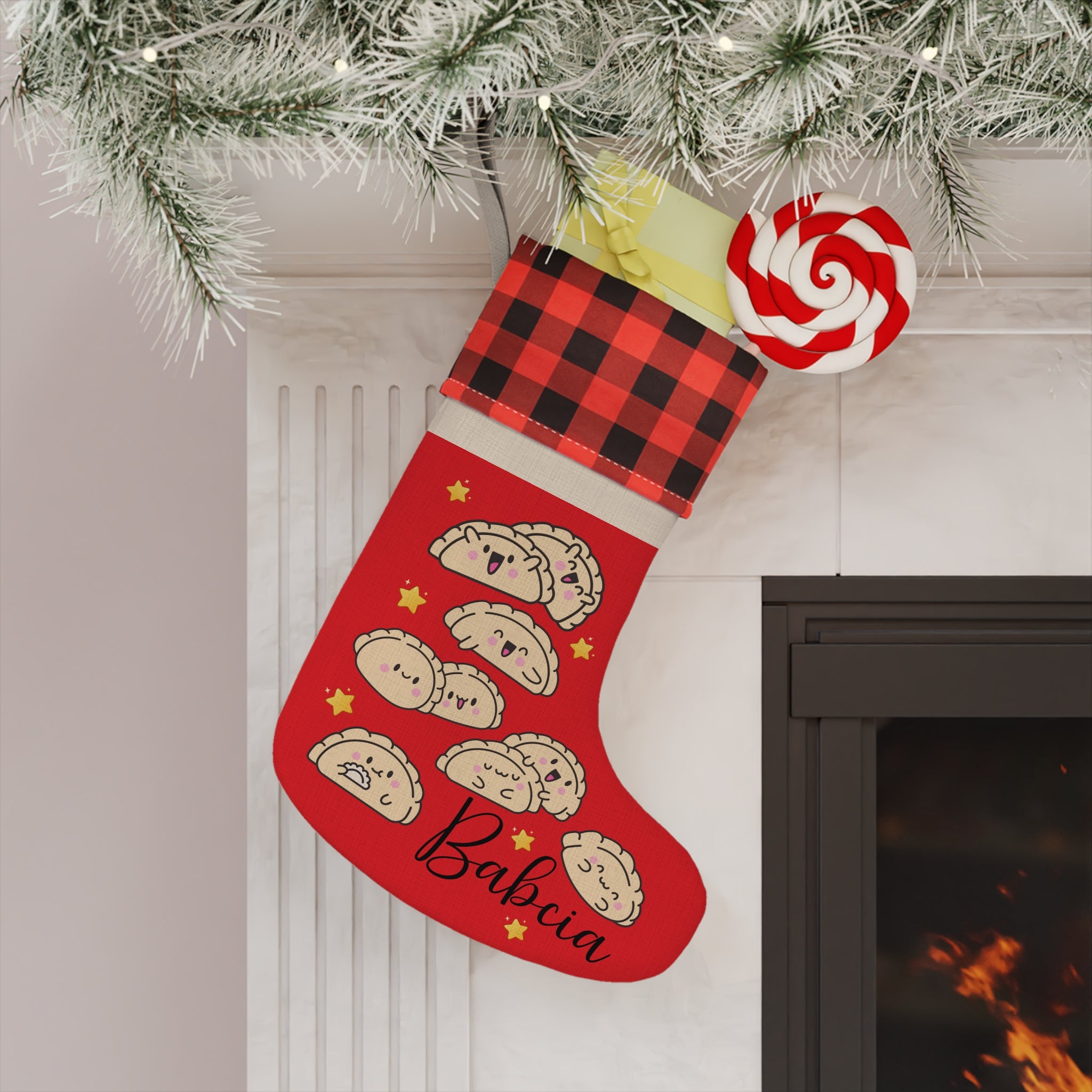 Red Christmas stocking with cartoon pierogi designs and 'Babcia' text, hanging by a fireplace.