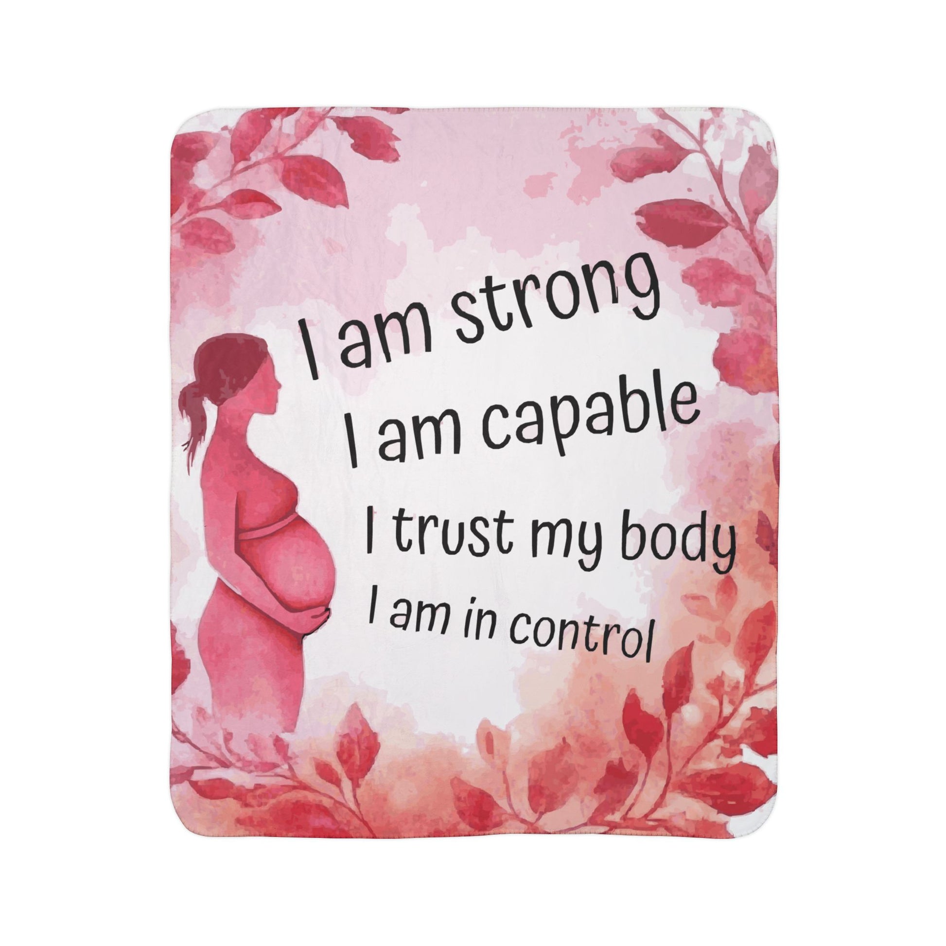 A Sherpa blanket with a floral design and pregnancy-related affirmations written on it.