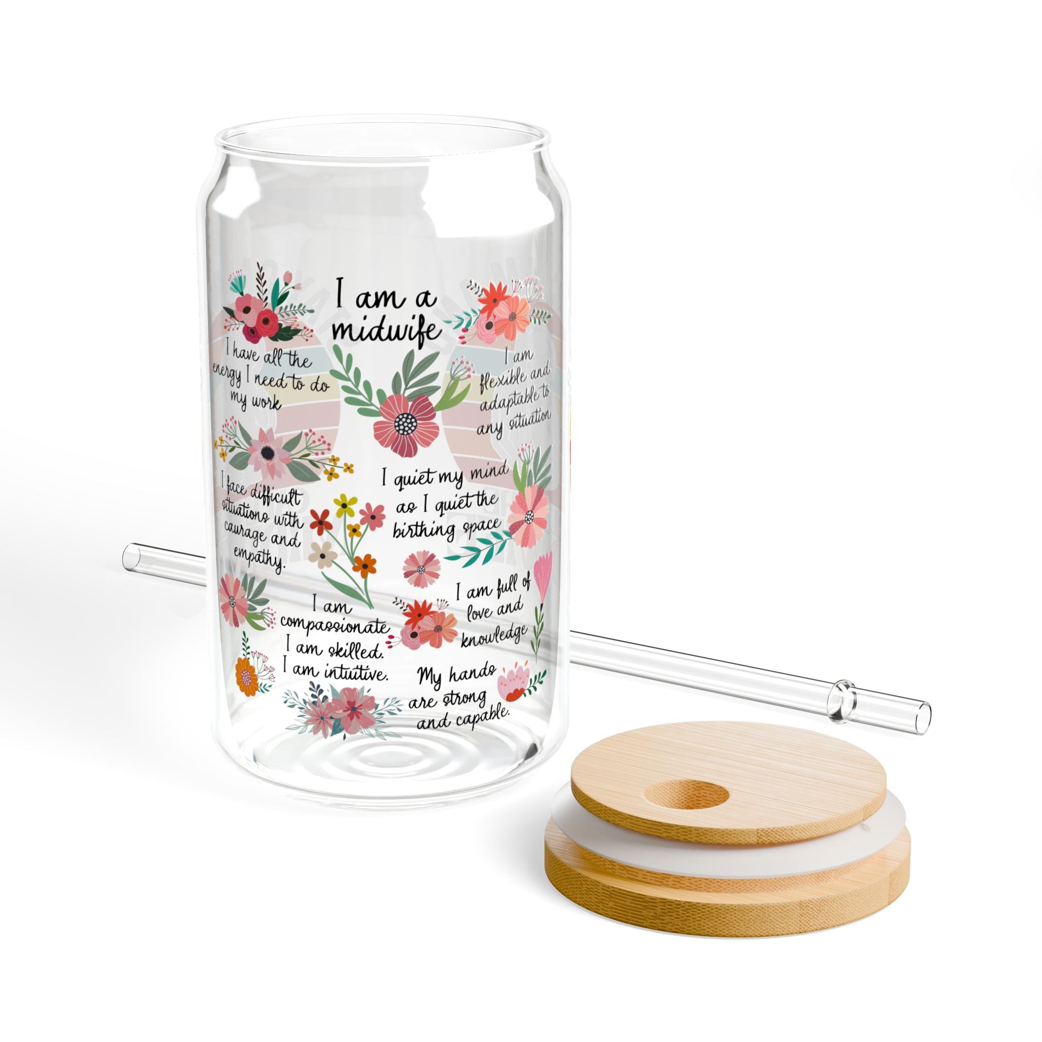 Glass tumbler with floral design and text, wooden lid, and straw on a white background
