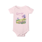 Baby onesie with "World is amazing" text and pastel nature design, made from soft 100% Airlume cotton, displayed flat with envelope neckline and snap closures.