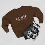 Brown sweatshirt with colorful text DOULA I'll be there for you, black denim jacket, and black sneakers on a light gray background