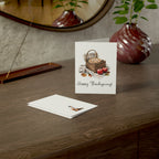 Greeting card with a basket and apples design on a wooden surface with a vase and mirror in the background.