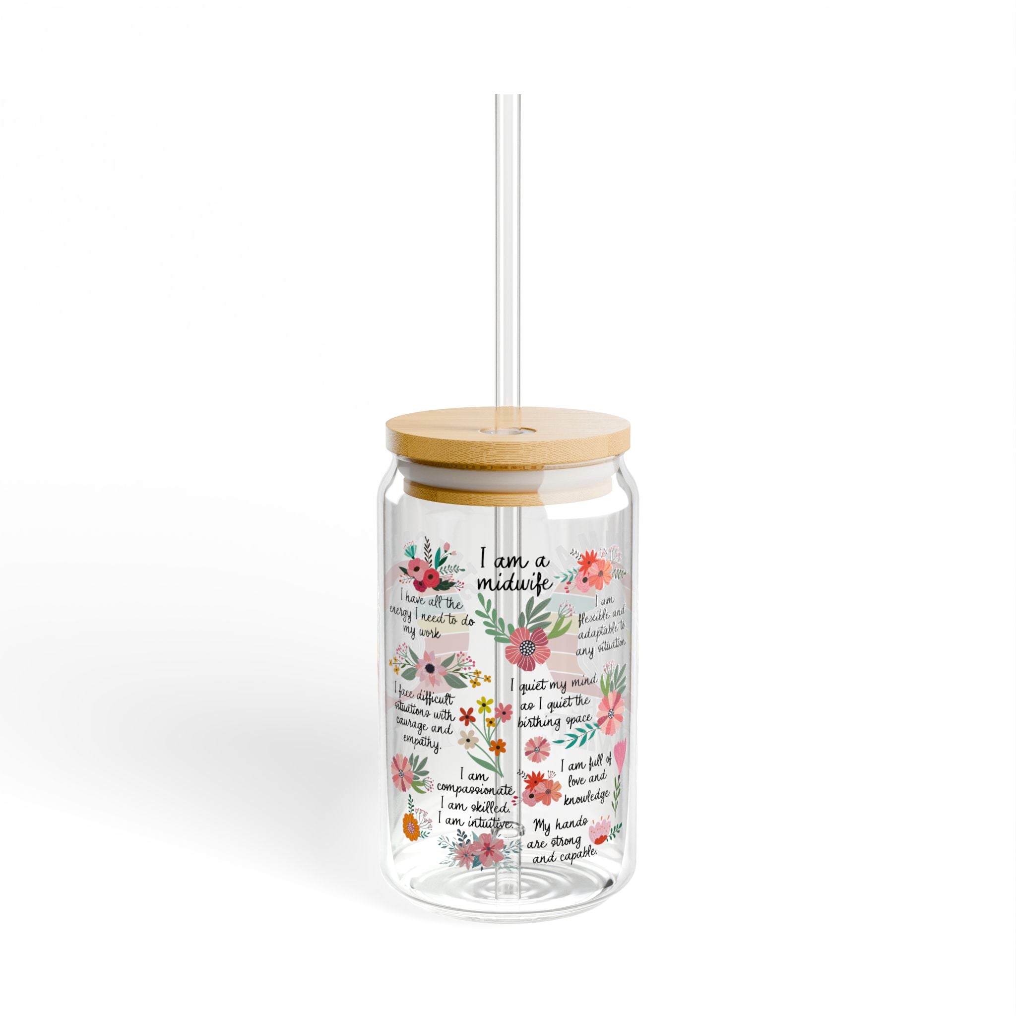 Clear tumbler with floral design and text, wooden lid, and straw on a white background