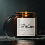 Candle with a label reading 'Smells like I'm in labor!' on a dark background