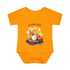 Orange baby onesie with 'Autumn Baby' design featuring a cup and leaves on a white background