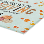 Thanksgiving-themed paper with pumpkins and leaves on a light blue background
