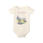 Baby onesie with "So grateful to be alive!" text and pastel nature design, made from soft 100% Airlume cotton, shown flat with envelope neckline and snap closures.