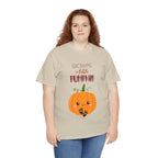 Person wearing a beige t-shirt with a pumpkin graphic and text on a white background