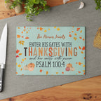 Thanksgiving-themed cutting board with decorative text and pumpkins on a kitchen surface.