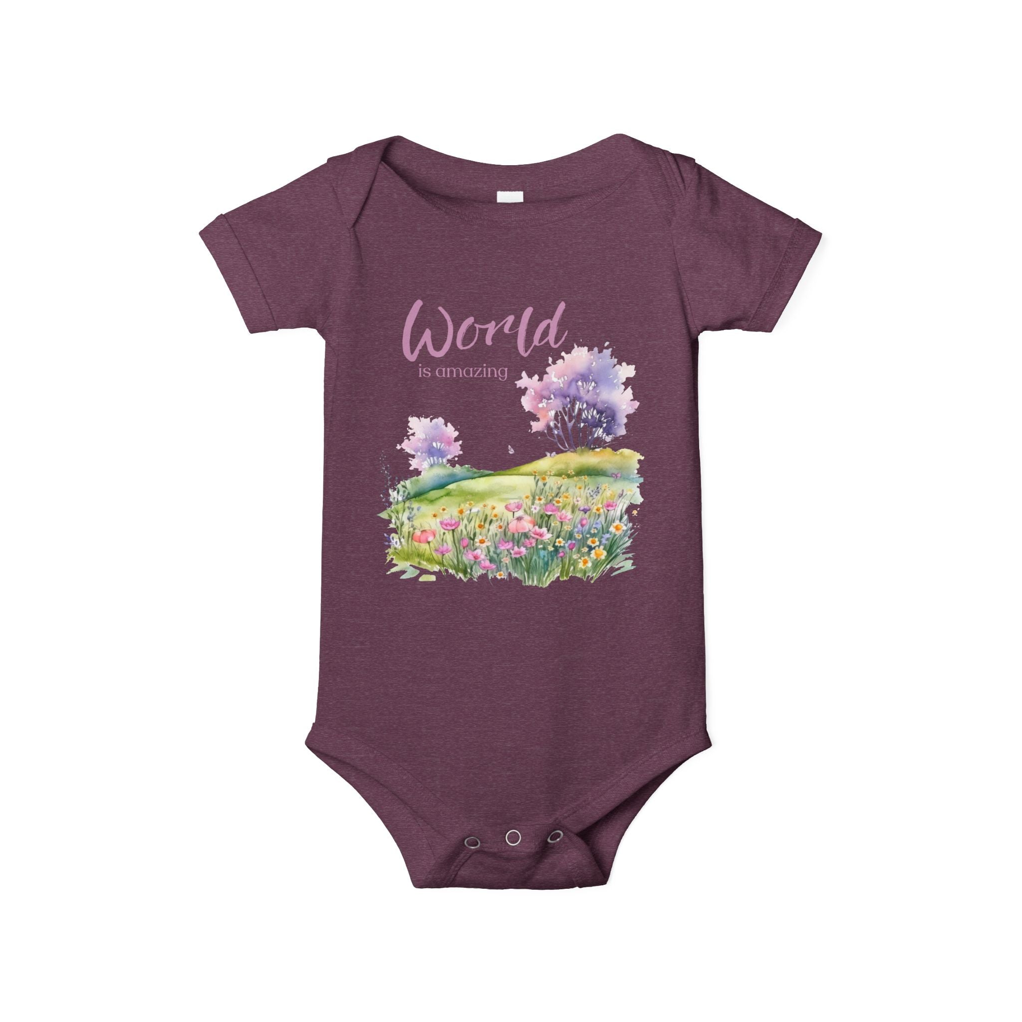 Baby onesie with "World is amazing" text and pastel nature design, made from soft 100% Airlume cotton, displayed flat with envelope neckline and snap closures.