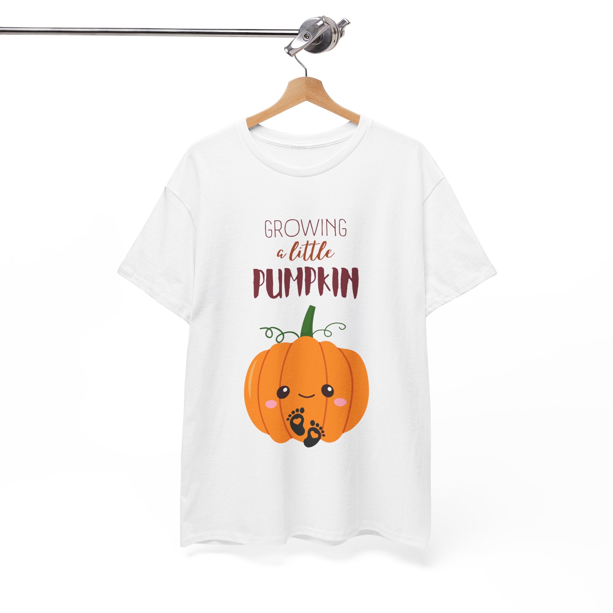 White t-shirt with a pumpkin graphic and text on a hanger against a white background