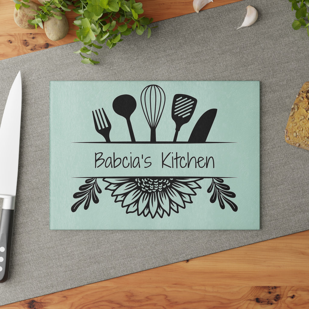 Decorative glass cutting board with utensil design and 'Babcia's Kitchen' text. For Polish babcia in the USA.