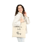 Natural cotton Christian tote bag with 'Walking by Faith and Carrying Diapers' text, designed for moms, featuring sturdy canvas handles and faith-inspired message.