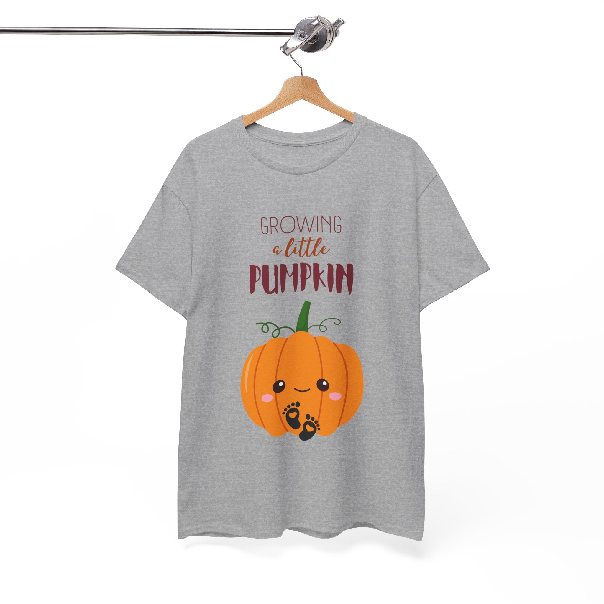 Gray t-shirt with a pumpkin graphic and text on a hanger against a white background