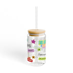 Clear tumbler with motivational phrases for birth and pregnancy and a wooden lid on a white background