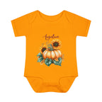 Orange baby onesie with pumpkin and sunflower design on a white background
