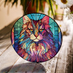 Stained glass suncatcher featuring a Norwegian Forest Cat with vibrant colors, hanging in a window and glowing in natural sunlight
