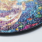 Close-up of a colorful stained glass suncatcher with angel with a gradient of blue, purple, and pink.