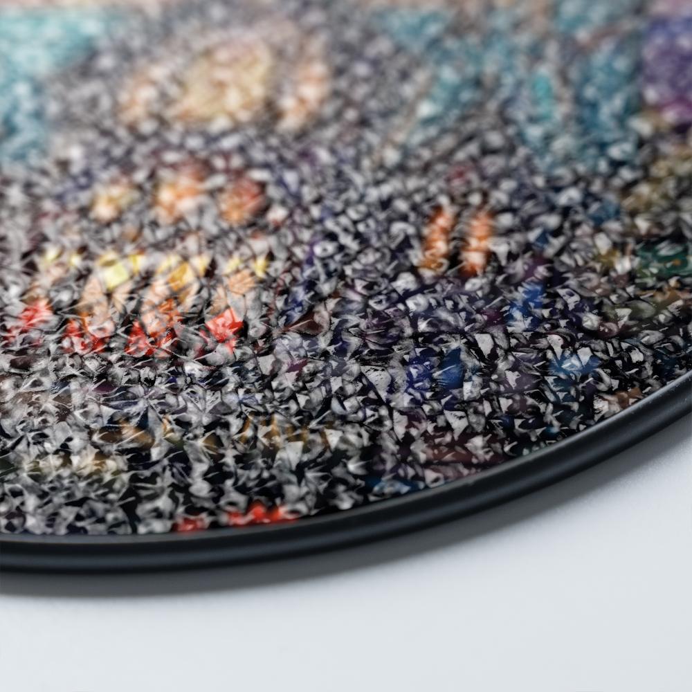 Stained glass suncatcher featuring a gothic mansion with a full moon, hanging in a window and glowing in natural sunlight details