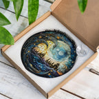 Decorative stained glass suncatcher with celestial design in a box on a wooden surface