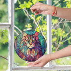Stained glass suncatcher featuring a Norwegian Forest Cat with vibrant colors, hanging in a window and glowing in natural sunlight