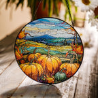 Round stained glass panel with autumn scene featuring pumpkins and leaves on a wooden surface.
