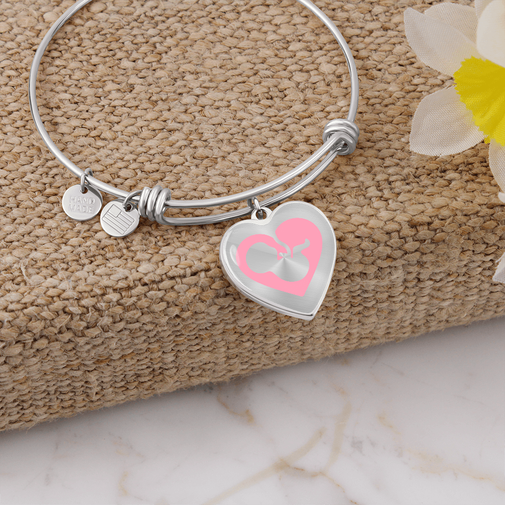 Pro-Life silver Heart Bracelet, featuring a graceful fetal silhouette embraced in a soft pink heart