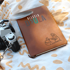 Journal for a doula on a premium vegan leather cover, includes 200 lined pages, a ribbon bookmark, and a brown elastic closure band.
