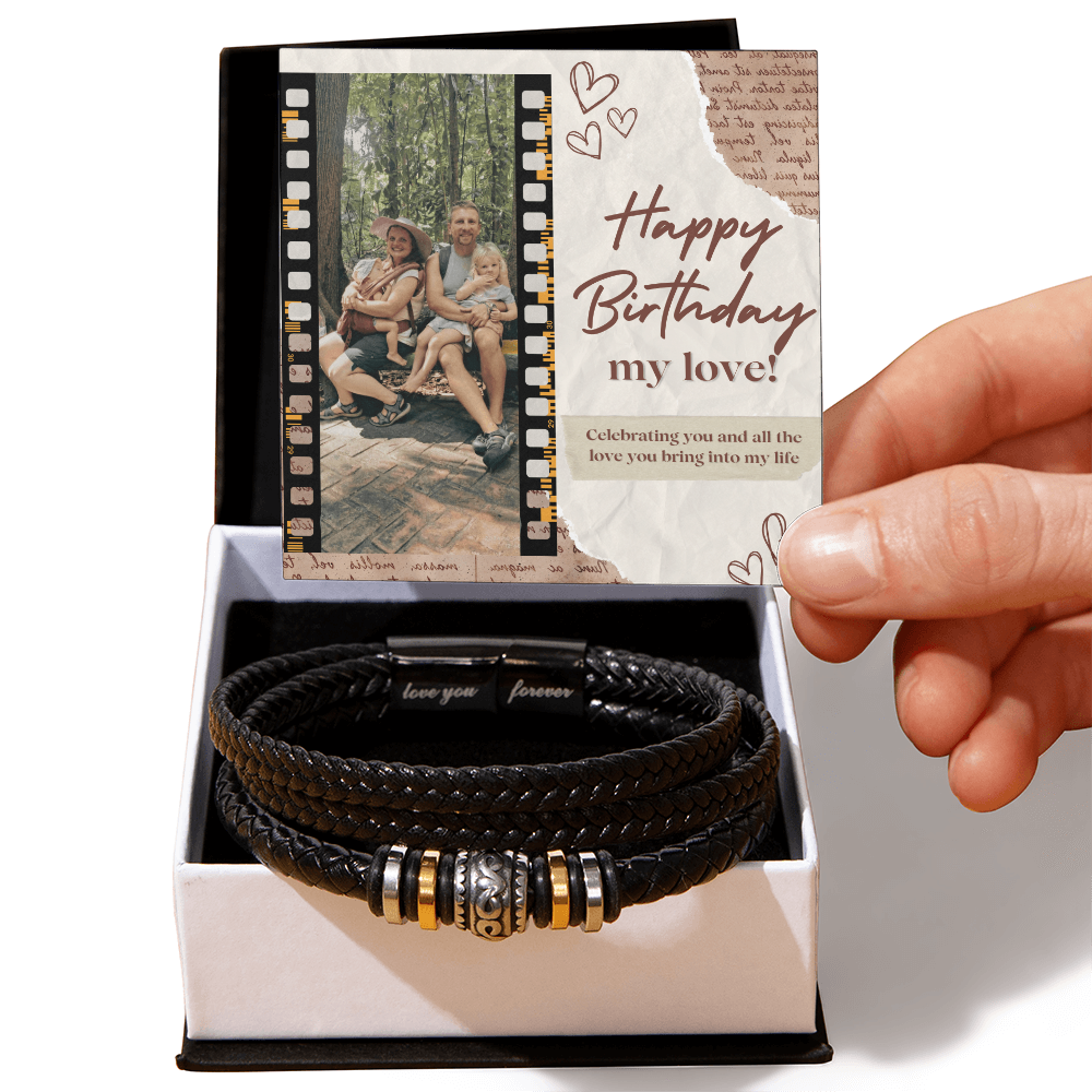 A personalized black bracelet with a decorative bead and a custom note, presented in a wooden box with a photo and a birthday message.