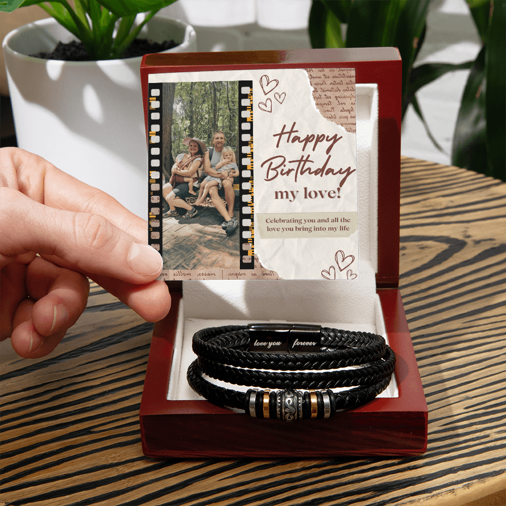 A personalized black bracelet with a decorative bead and a custom note, presented in a wooden box with a photo and a birthday message.